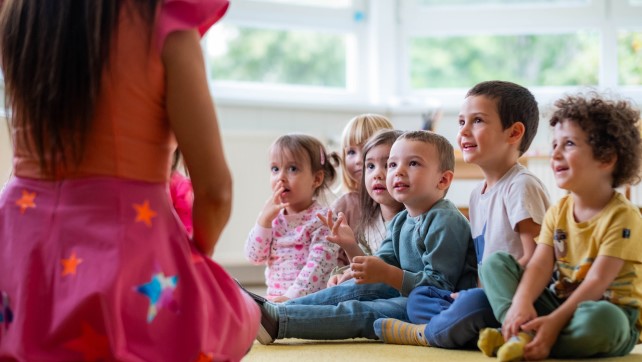 Children at the birthday party with the animator, laughing
