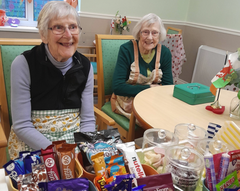 Women in a care home with their tuck shop
