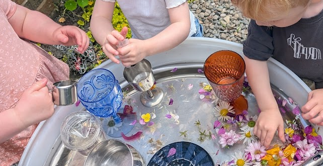 children playing with flower petals