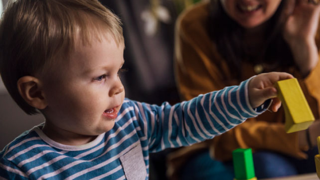 toddler plays with building blocks